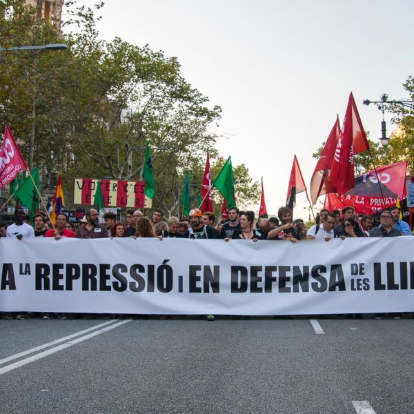 This is a photo of protesters in Barcelona during the Catalan general strike on October 3, 2017. In their hands, they carry banners that say, “Against repression and in defense of freedoms”, likely alluding to the earlier ruling by the Spanish Constitutional Court. The referendum itself had a 90% rate of approval of independence, but only around 43% of eligible voters participated.